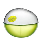 DKNY Be Delicious perfume in a round green bottle with a white top.
