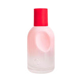 Glossier You perfume bottle with a pink gradient and red cap.